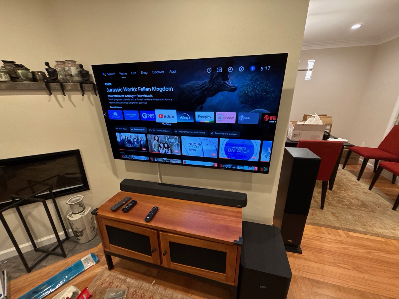 Television mounted in a living room above a console with a soundbar