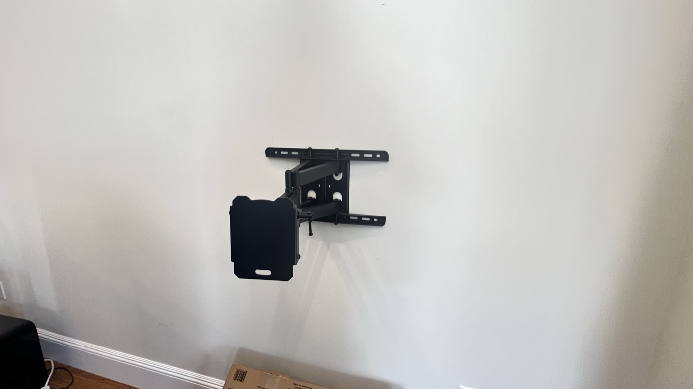 Full-motion articulating mount bracket installed on a bare wall